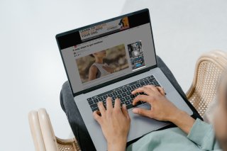 A woman looks at a healthcare ad on her laptop