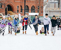 Datmouth students ice skating with big smiles on their faces