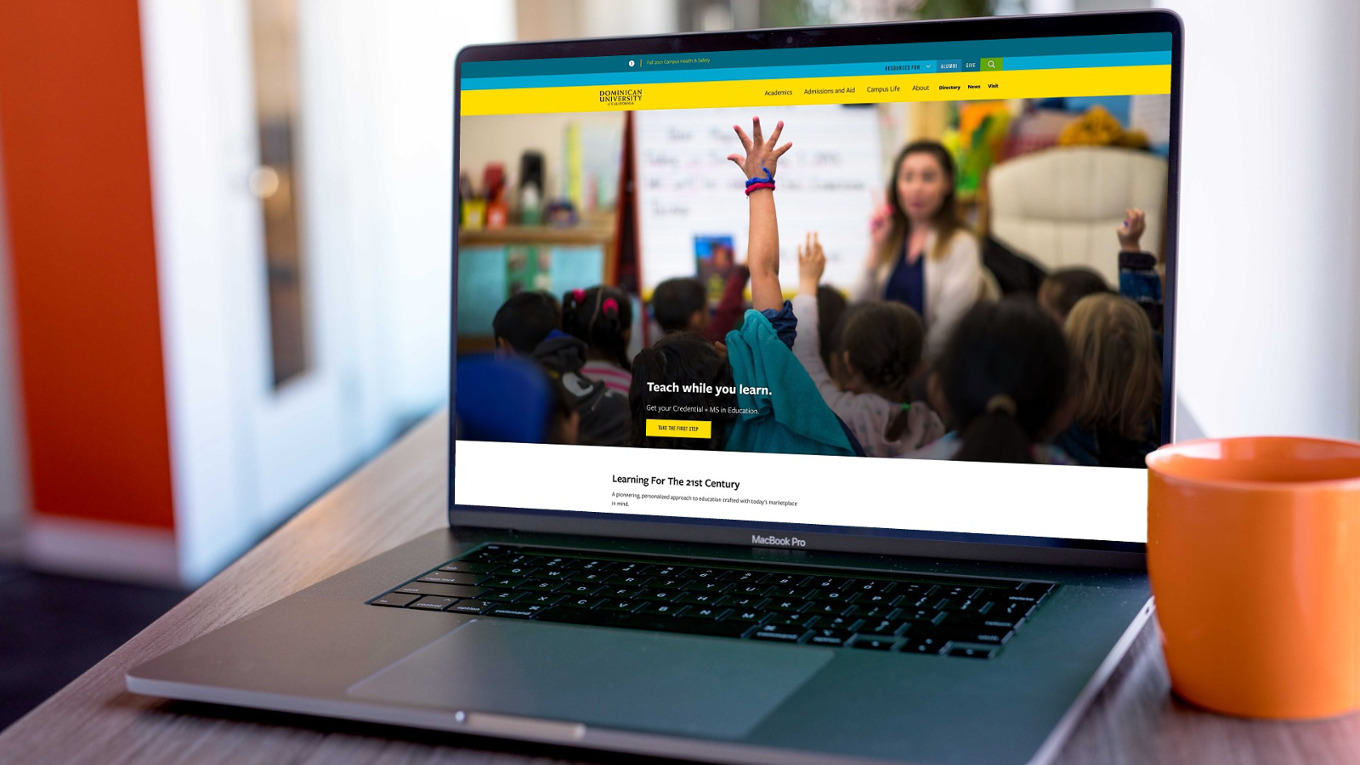 The Dominican University of California homepage displayed on a laptop