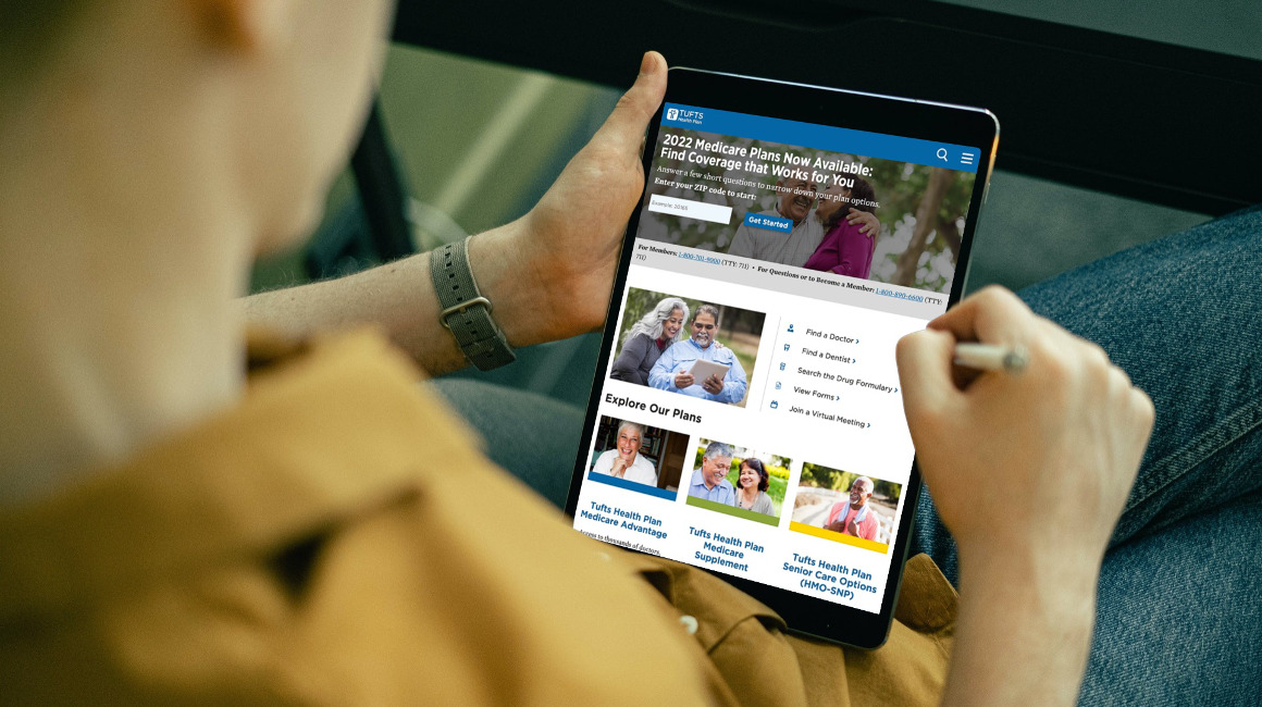 A man looks at health care plans on his tablet