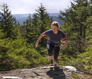 A woman hikes up a mountain