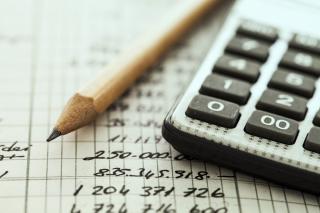 Pencil and Calculator laying on a notebook