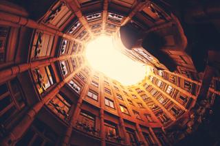 view from the ground, trapped inside a circle of tall buildings