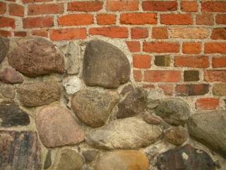 a stone foundation supporting a brick structure