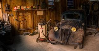 an old car collecting dust in a garage