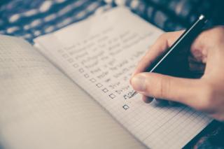 A checklist written in a notebook