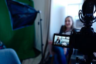 A woman being filmed as the subject of a testimonial video