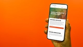 A landing page for the Miami Herbert Business School, displayed on an mobile device