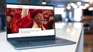 The USC Rossier homepage displayed on a laptop