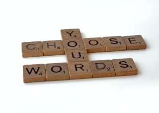 'Choose Your Words' spelled out with scrabble tiles