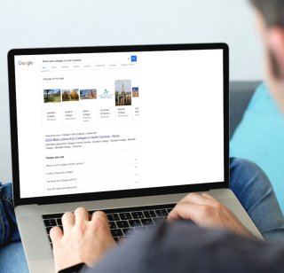 A prospective student searches for liberal arts colleges in North Carolina on a laptop