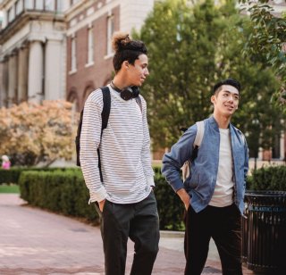 Two college students take a walk on campus