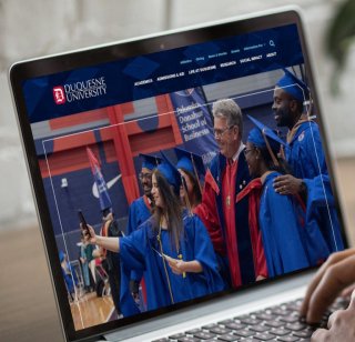 The Duquesne University website displayed on a laptop