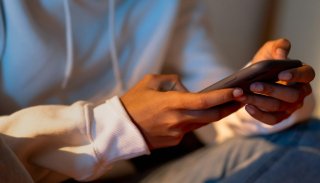 Student's hands holding a mobile device