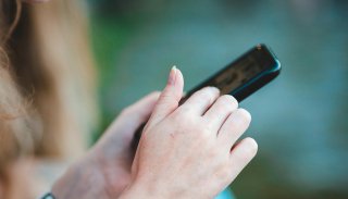 Woman holding a mobile device