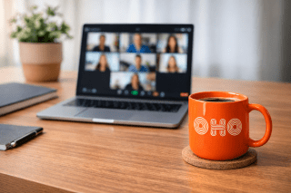 OHO mug in front of an open laptop