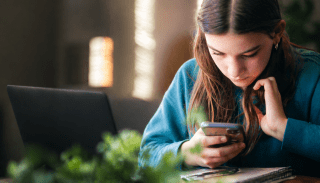 Student in front of her laptop and phone